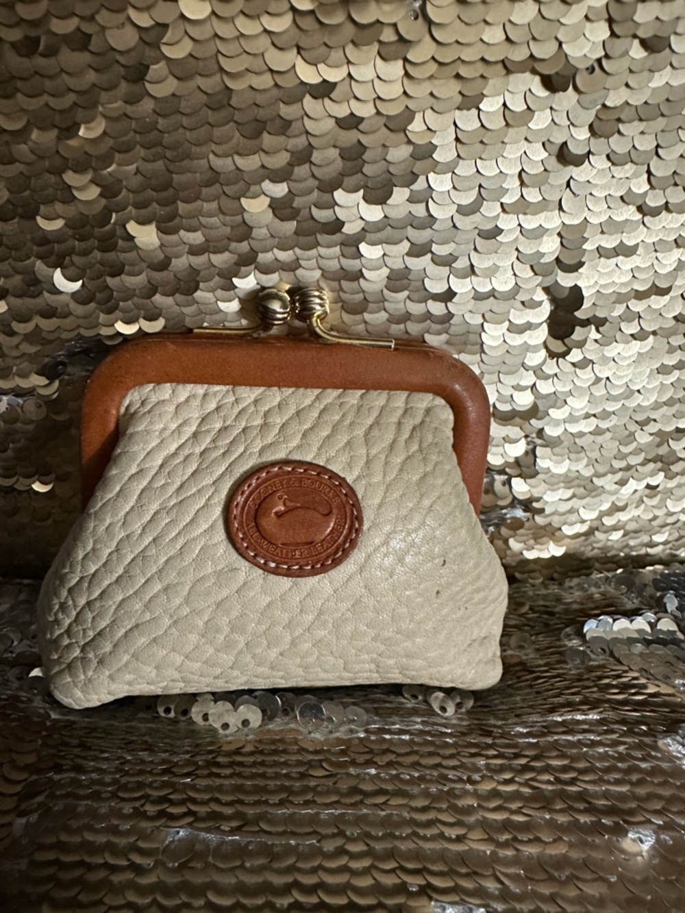 Vintage Dooney&Bourke coin purse kiss lock closure . Used but still cute .